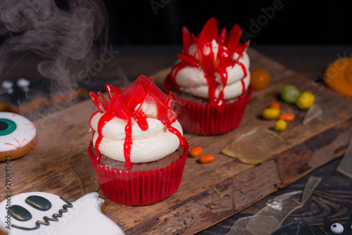 Halloween party and decoration conceptt. Halloween cupcakes and colored sweets photo