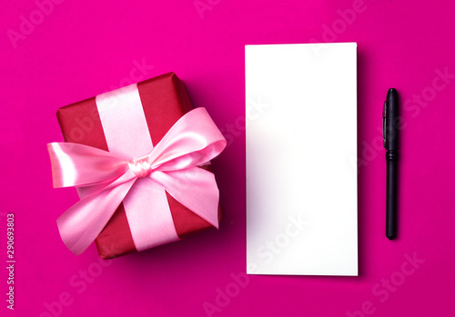 Gift box on a beautiful background with a satin ribbon. Holiday concept