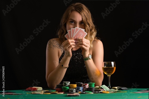 Girl playing cards in a casino. Concept of poker, playing cards.