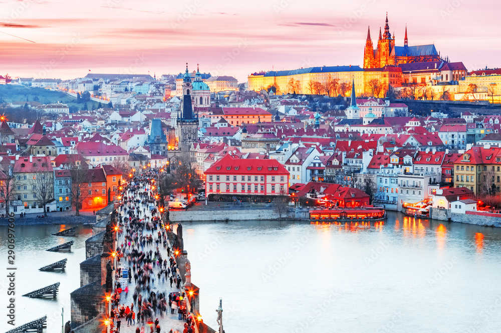 Prague, Czech Republic. Glorious view of Charles bridge and Hradcany Prague castle during awesome evening glow. Sunset scenery of city in lights. UNESCO site, popular European touristic city.