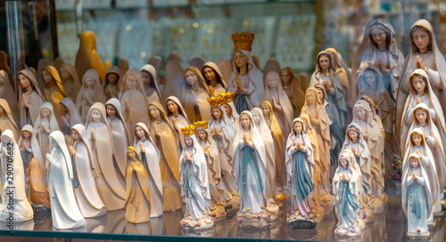 Quadro su tela statues or figurines in a shop, the commercial side of Lourdes.