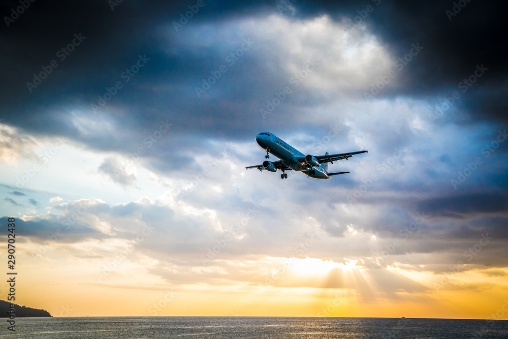 Landing plane in Sunset on the beach of Phuket Landing plane in Sunset on the beach of Phuket