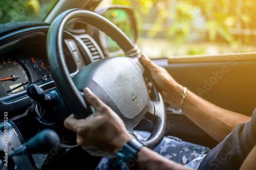 Man who wearing  watch is driving vehicle while working or going to somewhere.
