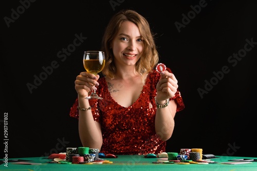 A woman plays in a casino. Woman puts a lot of chips. Gaming business and entertainment.