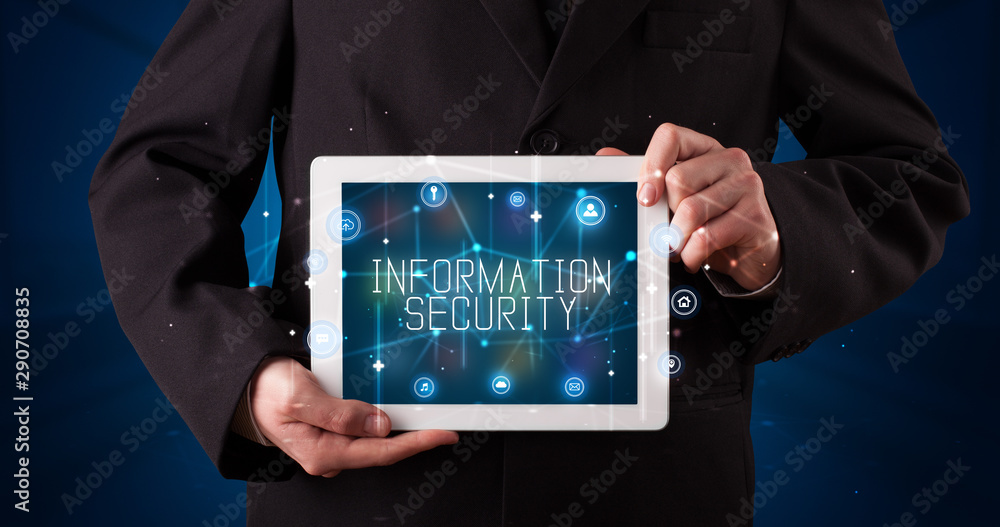 Young business person working on tablet and shows the digital sign: INFORMATION SECURITY Young business person working on tablet and shows the digital sign: INFORMATION SECURITY