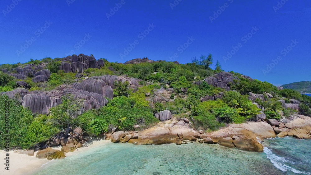 Overhead aerial view of beautiful Seychelles Beach and mountains in La Digue