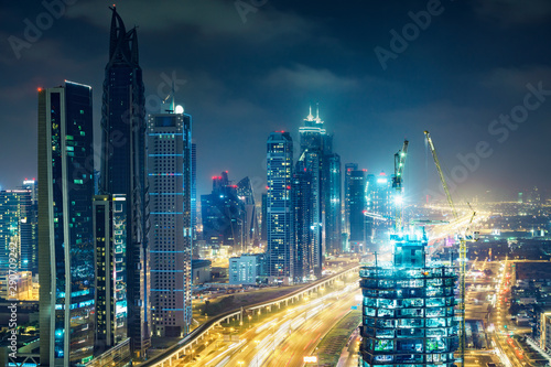 Downtown Dubai at night. Elevated view on highways and skyscrapers.