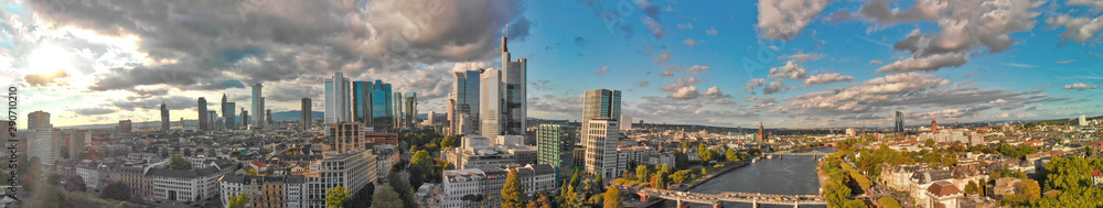Aerial flying along the futuristic skyline the business and financial centre of Frankfurt am Main, sunset panoramic view from drone