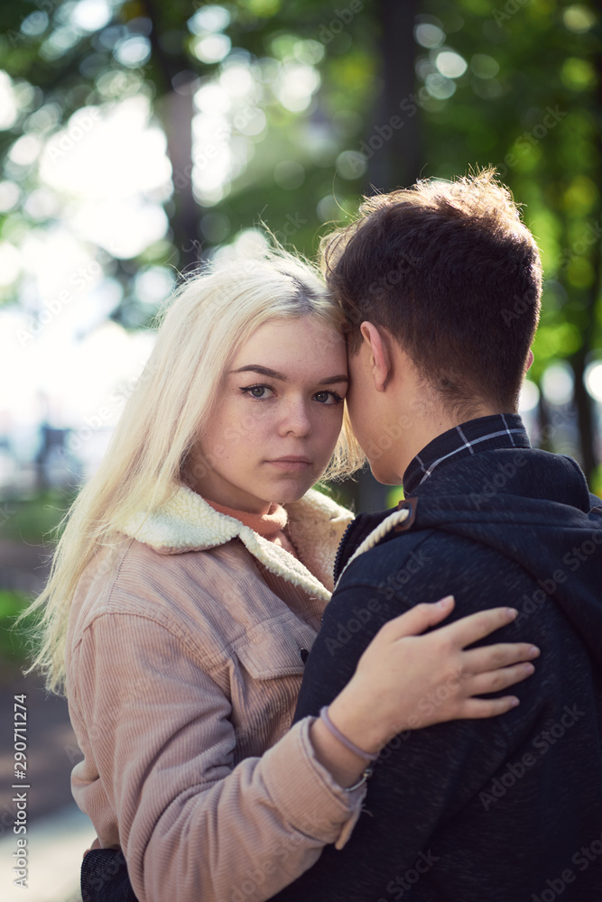 Girl put her head on his head, love in autumn park, teen couple. Concept of relationship teenagers Girl put her head on his head, love in autumn park, teen couple. Concept of relationship teenagers