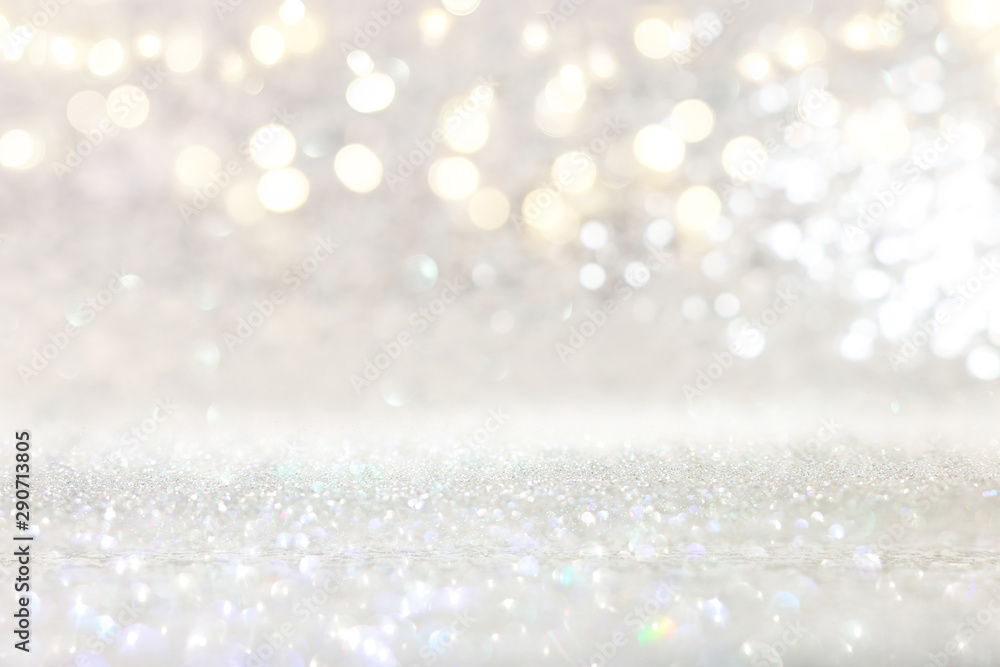 abstract backgrounf of glitter vintage lights . silver and white. de-focused