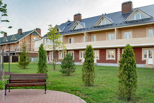  beautiful rural village with two-story houses and trees on a summer day