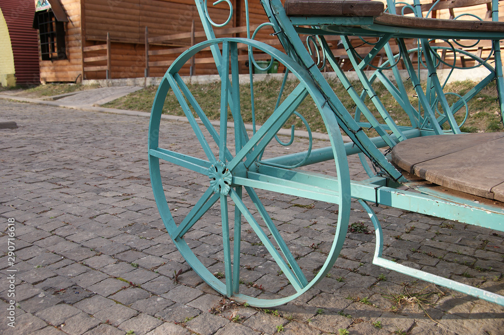 iron carriage wheels. fragment of a decorative turquoise carriage