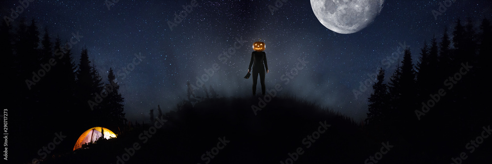 Obraz premium Halloween theme: scary maniac with pumpkin head in dark forest on sky background with midnight moon. People in camping don't know what the danger. Horrible fantasy. October, horror concept.