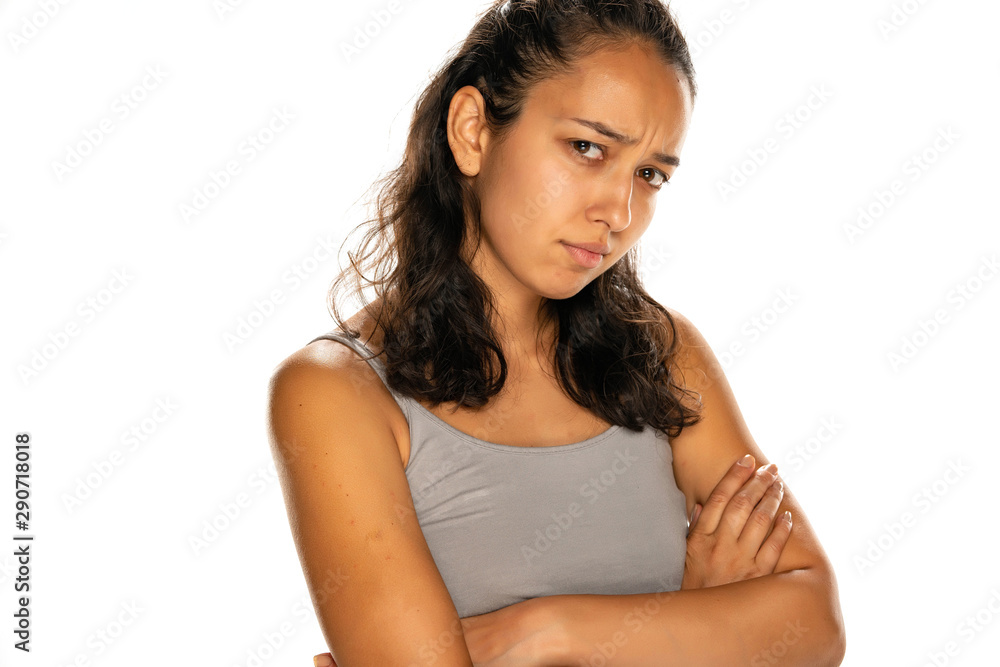 portrait of unhappy young latin woman on white background portrait of unhappy young latin woman on white background