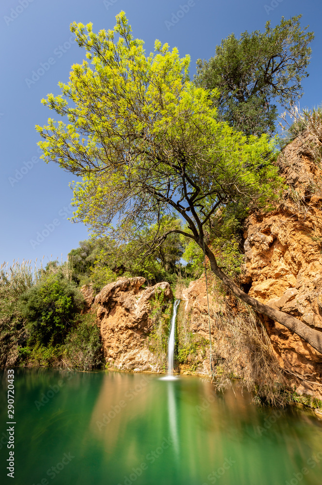 Obraz premium Pego do Inferno waterfall in Tavira, Portugal - Algarve Beautiful green lagoon