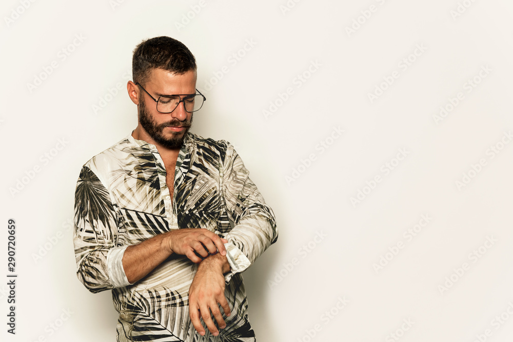 Fototapeta premium Young man with eyeglasses, looking down