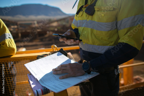 Картината върху платно Miner supervisor checking site emergency phone number before sigh of confined sp