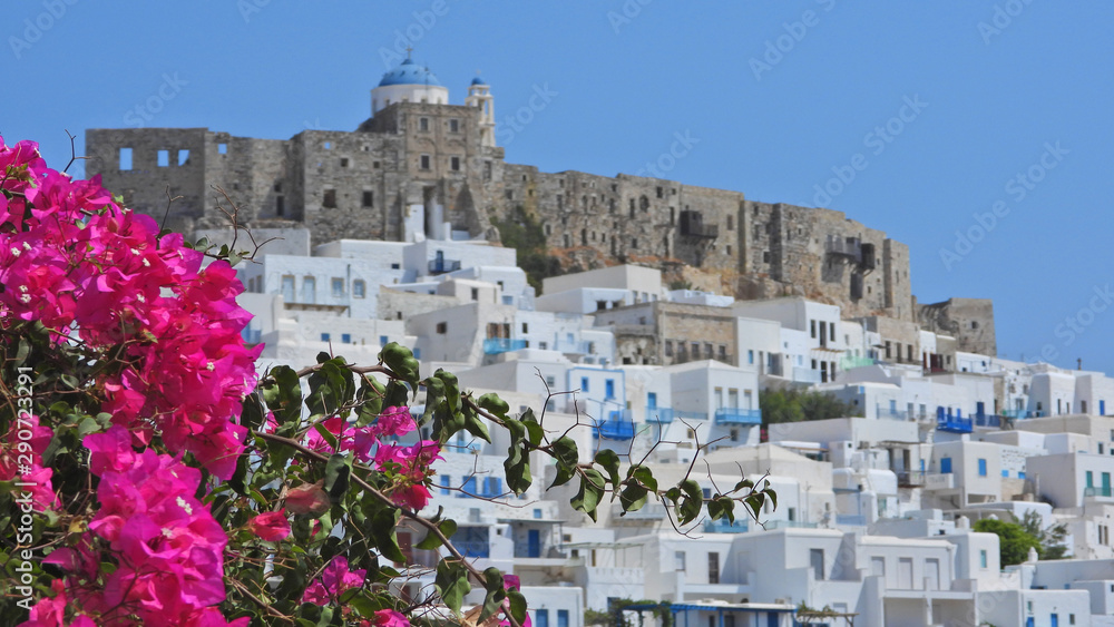 Zoom photo of iconic castle in main village of Astypalaia with beautiful bougainvillea flower, Dodecanese, Greece