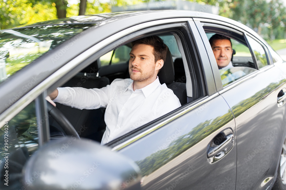 transport, vehicle and people concept - male driver driving car with passenger transport, vehicle and people concept - male driver driving car with passenger