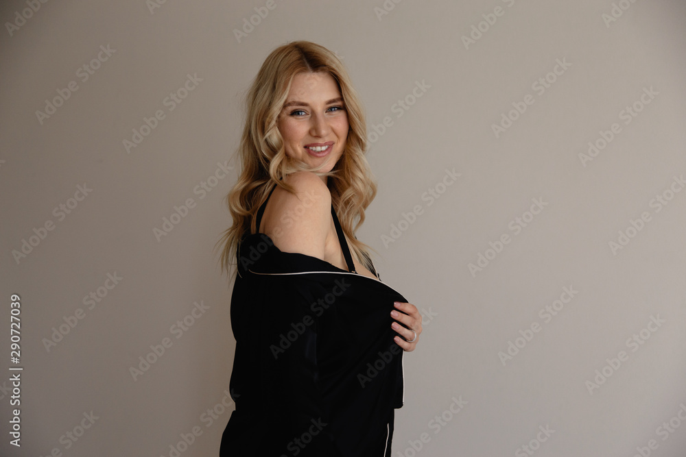 Sexy tender blonde woman in evening gown robe and black lingerie prepairing to go sleep to bed - Beautiful curly hair Sexy tender blonde woman in evening gown robe and black lingerie prepairing to go sleep to bed - Beautiful curly hair