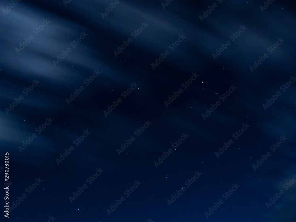 Stars and clouds at dark blue night sky background
