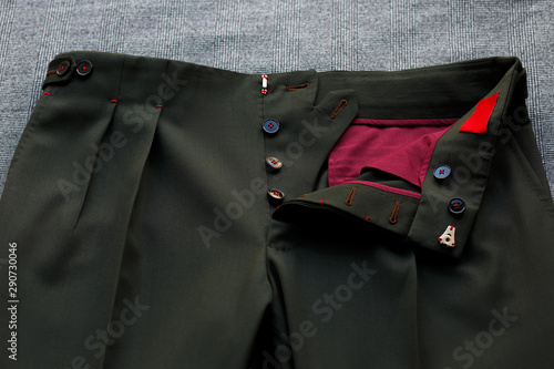 Bespoke rifle-green pants, details. Close-up view. photo