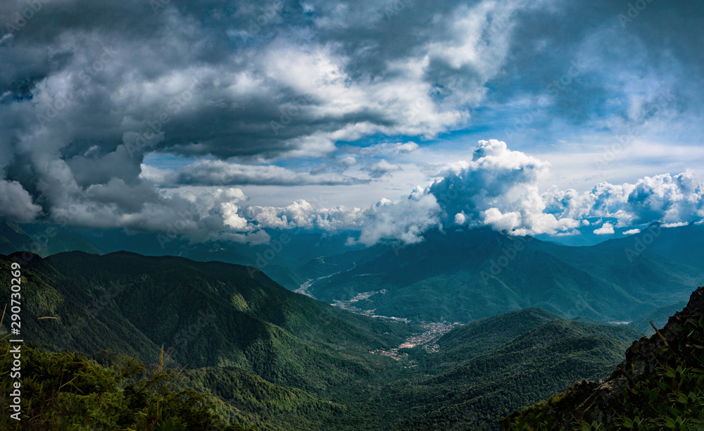 Panoramic view of cumulus clouds over Krasnaya Polyana at mountains background in Sochi, Russia