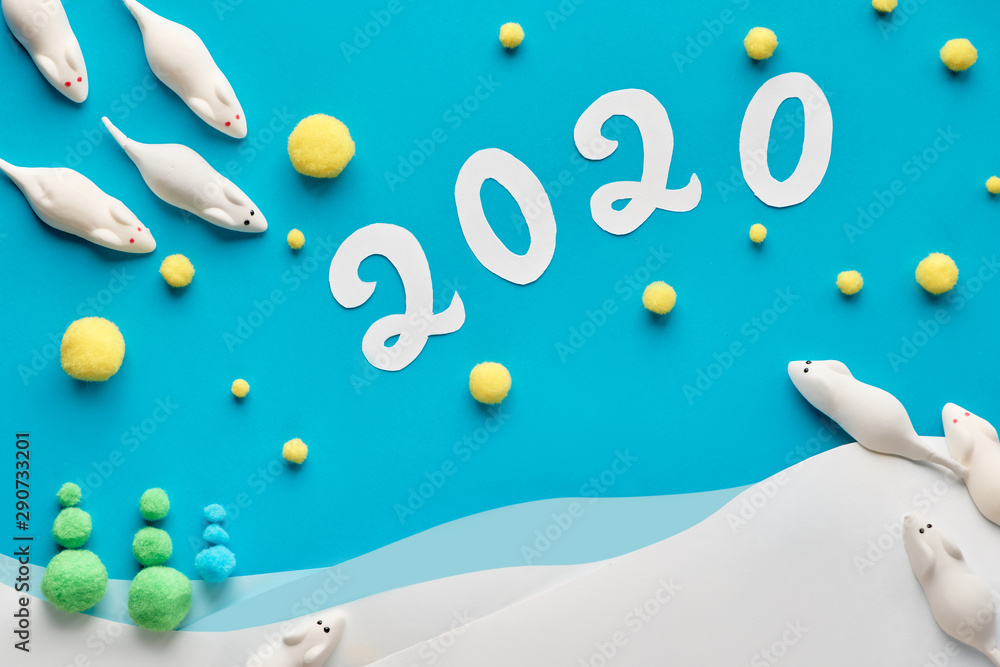 Paper flat lay in blue and white with marshmallow mice and paper number 2020 Paper flat lay in blue and white with marshmallow mice and paper number 2020