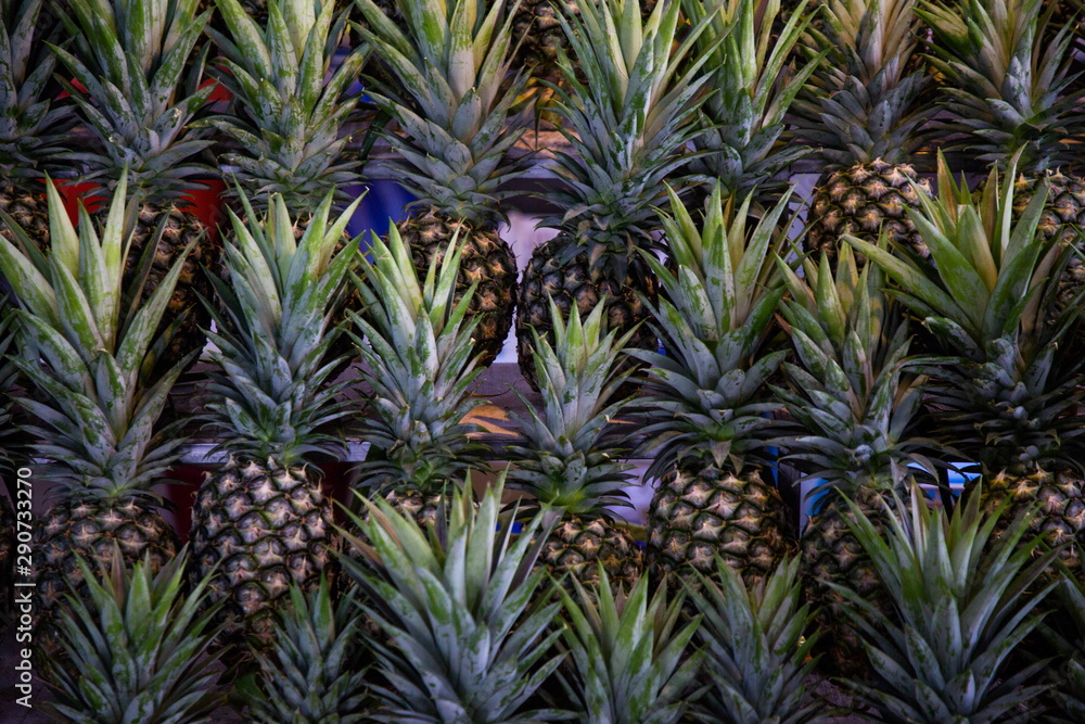 Obraz premium heap of pineapple fruits in market .