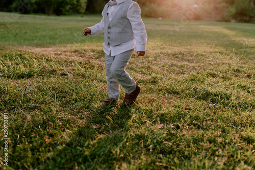 Pictures of a child walking on a grass field