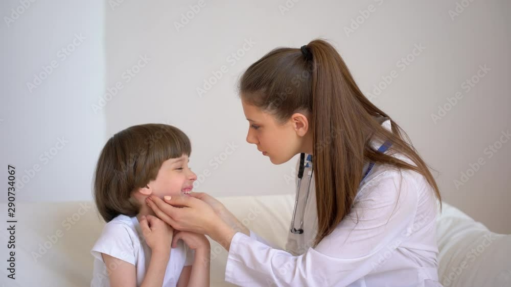 cold flu virus disease, sick kid child. Little boy is with young woman female pediatrician doctor cheking of cute little patient during medical examination in hospital, healthcare, pediatrics, 4 K cold flu virus disease, sick kid child. Little boy is with young woman female pediatrician doctor cheking of cute little patient during medical examination in hospital, healthcare, pediatrics, 4 K
