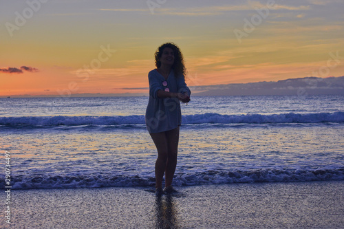 funny girl at sunset on the beach