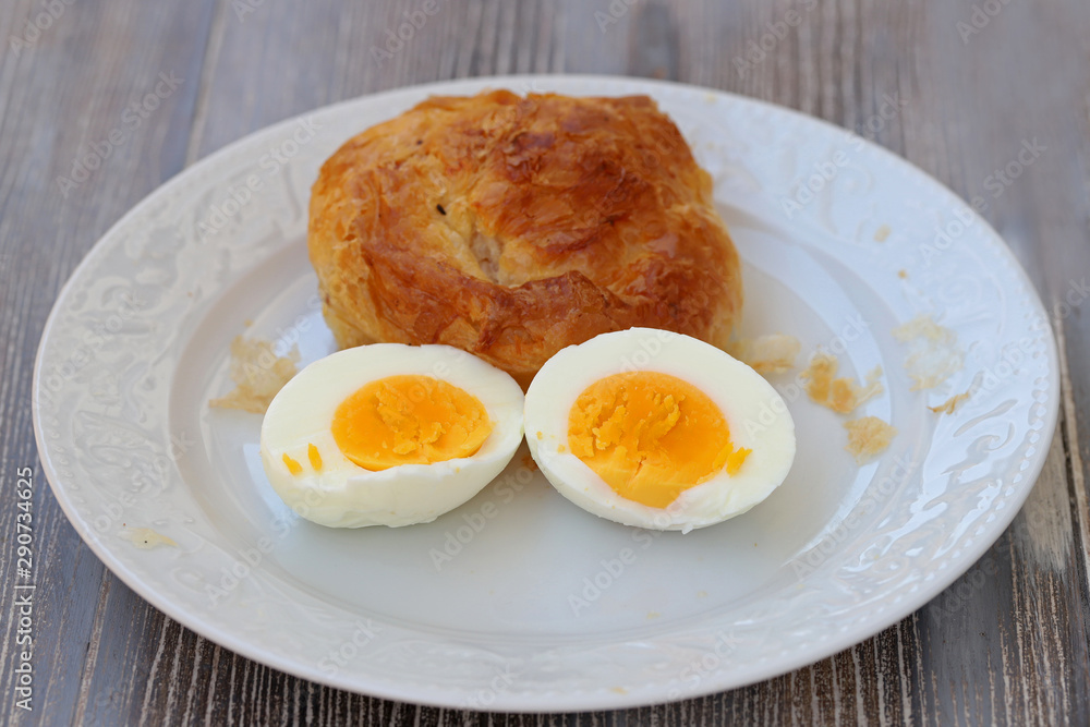 Boyoz and eggs cut in half in white plate. Boyoz and eggs cut in half in white plate.