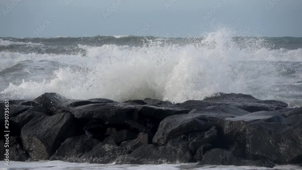 Waves rolling on the beach is a stormy day, winter mediterranean sea. Focene, Lazio, Italy. Slow motion Waves rolling on the beach is a stormy day, winter mediterranean sea. Focene, Lazio, Italy. Slow motion