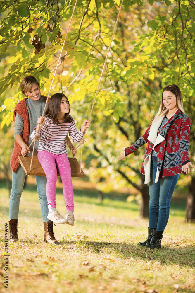 Obraz premium Beautiful mother and aunt with a child outdoors