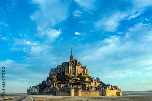 Dawn in Mont Saint Michel and its abbey with the sea at low tide
