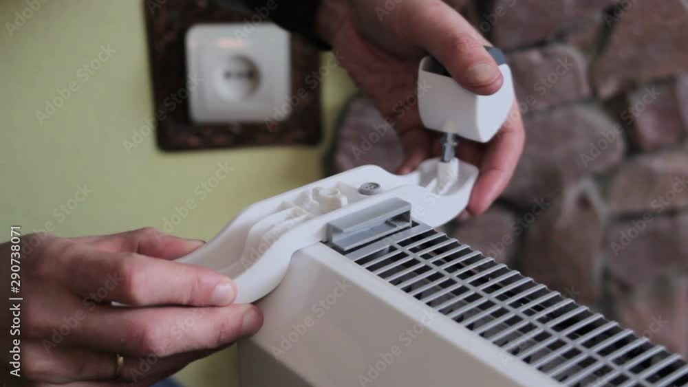 assembly of an electric heater,hands secure the wheels to an electric heater at home assembly of an electric heater,hands secure the wheels to an electric heater at home