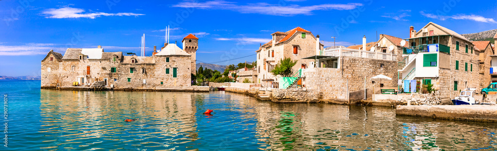 Landmarks of Croatia: Kastel Gomilica - old sea castle and traditional fishing village in Kastela, central Dalmatia - obrazy, fototapety, plakaty 