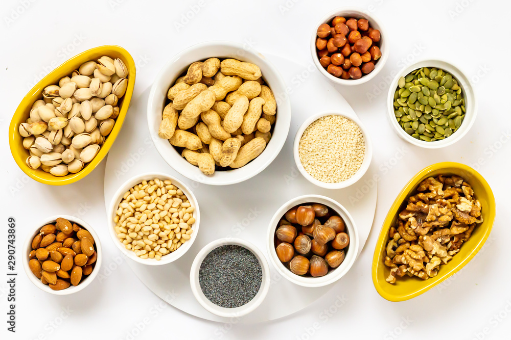 Various Nuts and Seeds on White Background in the Bowls - Image Various Nuts and Seeds on White Background in the Bowls - Image