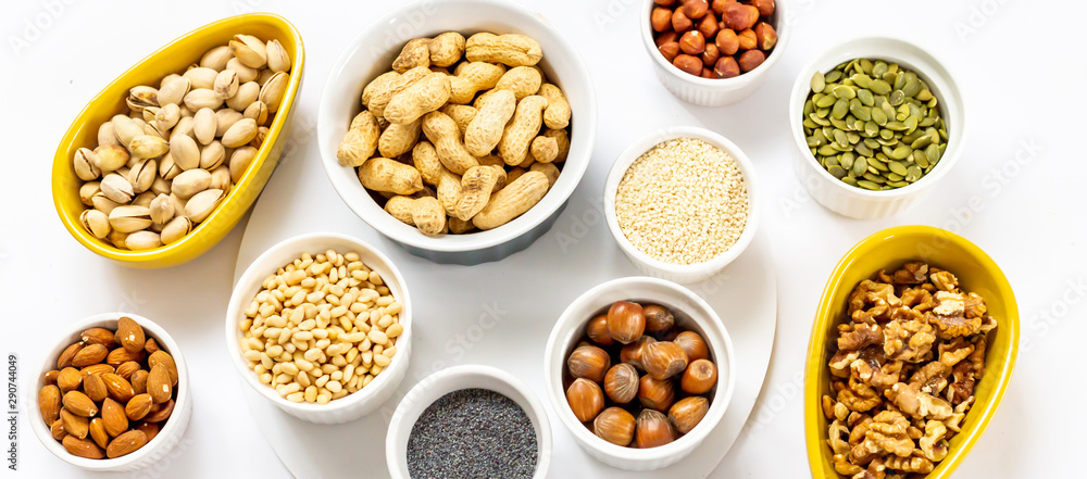 Panoramic View of Different Kind of Nuts and Seeds on White Background in the Bowls - Image Panoramic View of Different Kind of Nuts and Seeds on White Background in the Bowls - Image