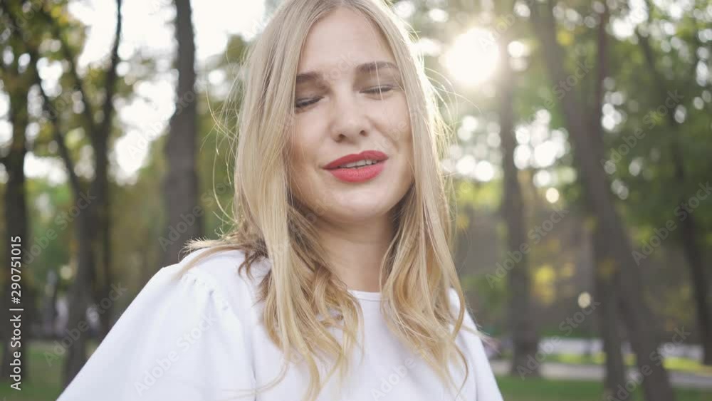 Attractive blond woman looking at the camera and away. Beautiful model smiling. Leisure outdoors, connection with nature. Attractive blond woman looking at the camera and away. Beautiful model smiling. Leisure outdoors, connection with nature.
