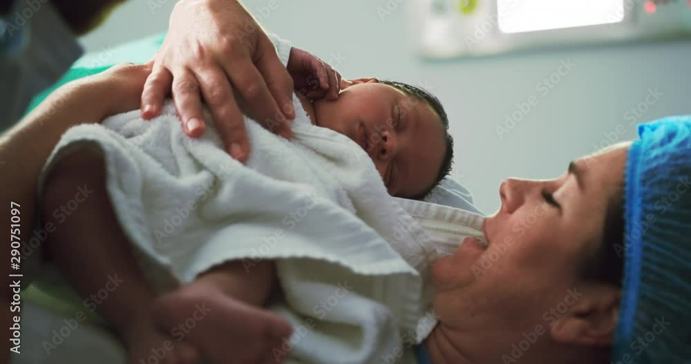 Close-up of Caucasian couple holding their newborn baby in operation theater Close-up of Caucasian couple holding their newborn baby in operation theater