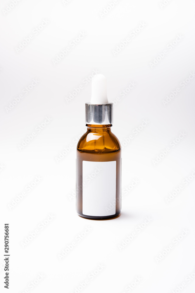 Brown glass cosmetic bottle mock-up with blank white label