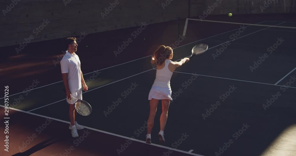 Woman and man playing tennis on a sunny day Woman and man playing tennis on a sunny day