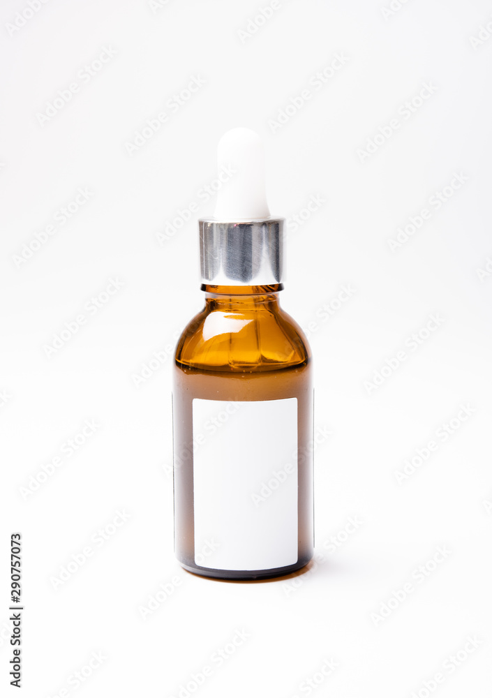Brown glass cosmetic bottle mock-up with blank white label Brown glass cosmetic bottle mock-up with blank white label