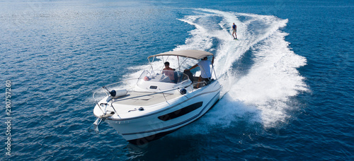 Tela Speedboat with wakeboard rider on open sea