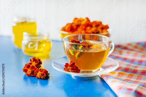 A cup of tea from the flowers of Chernobrivtsov. Processing of dried flowers marigolds. photo