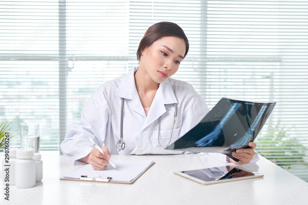 Female doctor is examined x-ray film Female doctor is examined x-ray film
