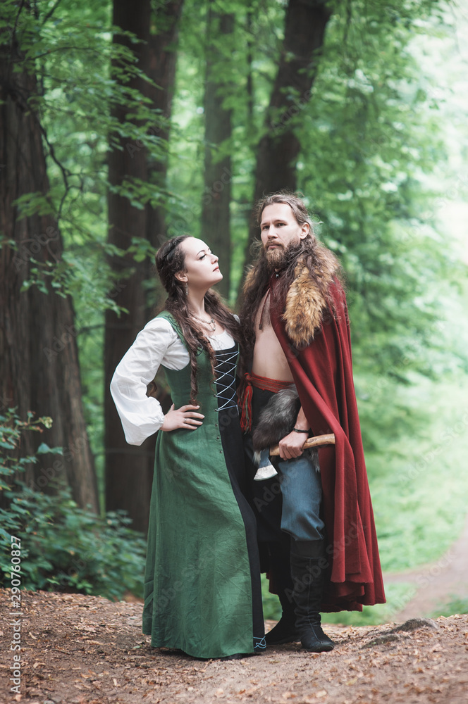 Brave Warrior Viking man with beautiful medieval woman outdoor Brave Warrior Viking man with beautiful medieval woman outdoor