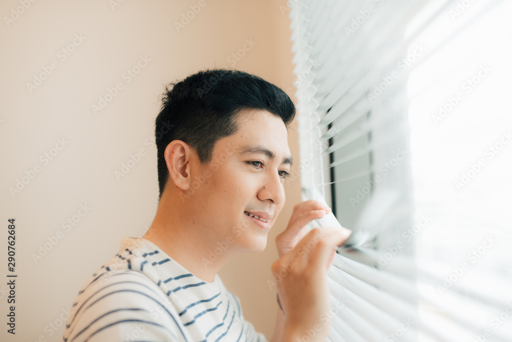 Man relaxing in his chair and enjoying the view from living room window Man relaxing in his chair and enjoying the view from living room window